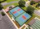 Aerial view of pickleball and shuffleboard courts in a fenced-in area, featuring a playground at 1429 Sw 160Th Ln, Ocala, FL 34473