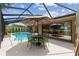 Inviting screened-in pool area with comfortable seating and a dining table for outdoor entertaining at 1429 Sw 160Th Ln, Ocala, FL 34473