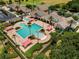Aerial view of community pool area with ample seating, umbrellas, and meticulously maintained landscaping at 1429 Sw 160Th Ln, Ocala, FL 34473