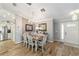 Charming dining room with wood-look tile floors, a chandelier, and access to the kitchen and front entry at 15119 Sw 14Th Avenue Rd, Ocala, FL 34473