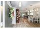 Inviting entryway featuring wood-look flooring, a decorative cabinet, and a view into the dining and living areas at 15119 Sw 14Th Avenue Rd, Ocala, FL 34473