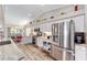 Modern kitchen with stainless steel appliances, white cabinets, and stone countertops; bright and spacious at 15119 Sw 14Th Avenue Rd, Ocala, FL 34473