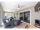 Enclosed lanai with tile flooring, comfortable seating, a ceiling fan, and views of the outdoors at 15119 Sw 14Th Avenue Rd, Ocala, FL 34473
