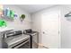 Laundry room featuring a washer, dryer, storage shelves, and a white door at 15119 Sw 14Th Avenue Rd, Ocala, FL 34473