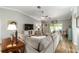 Comfortable living room with a large sectional sofa, wood-look tile floors, and a view of the outdoor space at 15119 Sw 14Th Avenue Rd, Ocala, FL 34473