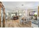 Open-concept living and dining area with wood floors and a neutral color palette at 15119 Sw 14Th Avenue Rd, Ocala, FL 34473