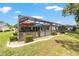 Screened-in patio with lounge furniture and a beautiful backyard view at 15119 Sw 14Th Avenue Rd, Ocala, FL 34473