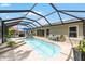 Sparkling pool area with comfortable lounge chairs, an outdoor dining area, and meticulous landscaping at 15119 Sw 14Th Avenue Rd, Ocala, FL 34473