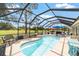 Screened in pool area with outdoor seating and a picturesque golf course view at 15119 Sw 14Th Avenue Rd, Ocala, FL 34473