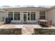 Paver patio with seating, outdoor grill, and views from large windows and door in the back of the home at 1748 Sw 157Th Place Rd, Ocala, FL 34473