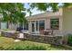 Outdoor patio features seating, a grill, and views of the backyard, accessible through large windows and a door at 1748 Sw 157Th Place Rd, Ocala, FL 34473