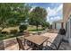 Cozy backyard brick patio with outdoor dining set overlooking the expansive lawn at 1748 Sw 157Th Place Rd, Ocala, FL 34473