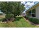 Landscaped backyard and stone-bordered flower beds are visible, adding to the property's charm at 1748 Sw 157Th Place Rd, Ocala, FL 34473