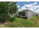 Backyard with stone-bordered flower beds and a view of the rear of the house at 1748 Sw 157Th Place Rd, Ocala, FL 34473