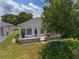 Charming backyard features a stone patio with outdoor seating, ideal for entertaining and relaxation at 1748 Sw 157Th Place Rd, Ocala, FL 34473