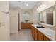 Bathroom with dual sinks, neutral tiled floors, walk-in shower, and vanity offering ample storage space at 1748 Sw 157Th Place Rd, Ocala, FL 34473