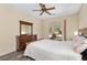 Serene bedroom boasts a cozy bed, wooden dresser, and sliding glass doors leading to a relaxing outdoor space at 1748 Sw 157Th Place Rd, Ocala, FL 34473