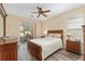 Cozy bedroom with wood floors, a ceiling fan, and sliding glass doors to an enclosed patio at 1748 Sw 157Th Place Rd, Ocala, FL 34473