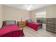 Cozy bedroom with two twin beds, a dresser, and a window offering natural light at 1748 Sw 157Th Place Rd, Ocala, FL 34473
