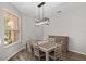 Dining room with modern light fixture and seating for six at 1748 Sw 157Th Place Rd, Ocala, FL 34473