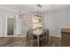 Well-lit dining area features a stylish light fixture and seating for six at 1748 Sw 157Th Place Rd, Ocala, FL 34473