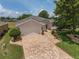 Well-maintained home with a spacious two-car garage and attractive brick paver driveway enhances curb appeal at 1748 Sw 157Th Place Rd, Ocala, FL 34473