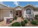Charming home entrance with a red door, brick pathway, and manicured landscaping at 1748 Sw 157Th Place Rd, Ocala, FL 34473
