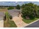 Charming single-story home featuring a brick paver driveway, attached garage, and lush, mature landscaping at 1748 Sw 157Th Place Rd, Ocala, FL 34473