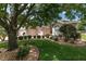 Charming front yard featuring manicured landscaping and a large shade tree at 1748 Sw 157Th Place Rd, Ocala, FL 34473