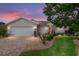Charming single-story home featuring a manicured lawn, brick driveway, and well-maintained landscaping at dusk at 1748 Sw 157Th Place Rd, Ocala, FL 34473