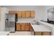 Spacious kitchen with stainless steel refrigerator and a breakfast bar perfect for casual dining at 1748 Sw 157Th Place Rd, Ocala, FL 34473