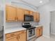 Bright kitchen with natural wood cabinets, stainless steel appliances, and sleek countertops for meal preparation at 1748 Sw 157Th Place Rd, Ocala, FL 34473