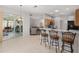Open kitchen with breakfast bar, pendant lighting, and a view of the adjacent living area and outdoor patio at 1748 Sw 157Th Place Rd, Ocala, FL 34473
