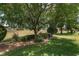 Landscaped yard featuring a large tree and meticulously kept bushes and grass at 1748 Sw 157Th Place Rd, Ocala, FL 34473