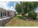 Manicured backyard with plush landscaping, mature trees, and decorative stone edging at 1748 Sw 157Th Place Rd, Ocala, FL 34473