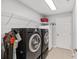 Functional laundry room with modern washer, dryer, and ample storage space and shelving at 1748 Sw 157Th Place Rd, Ocala, FL 34473
