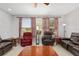Inviting living room featuring plush leather seating, bright windows, and stylish decor, creating a comfortable gathering space at 1748 Sw 157Th Place Rd, Ocala, FL 34473