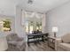 Cozy living room with wood floors, ample natural light, and comfortable seating at 1748 Sw 157Th Place Rd, Ocala, FL 34473