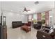 Spacious living room with tile floors, a ceiling fan, and large windows with red and white checkered curtains at 1748 Sw 157Th Place Rd, Ocala, FL 34473