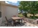 Outdoor patio features a table and chairs, a brick retaining wall, and golf course view at 1748 Sw 157Th Place Rd, Ocala, FL 34473