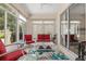 Bright sunroom with tile floors, comfortable seating, and sliding glass doors at 1748 Sw 157Th Place Rd, Ocala, FL 34473