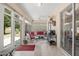 Inviting sunroom with tiled floor, comfortable seating, and expansive windows for natural light at 1748 Sw 157Th Place Rd, Ocala, FL 34473