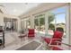 Inviting sunroom with tiled floor, comfortable seating, and expansive windows for natural light at 1748 Sw 157Th Place Rd, Ocala, FL 34473
