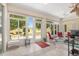 Inviting sunroom with tiled floor, comfortable seating, and expansive windows for natural light at 1748 Sw 157Th Place Rd, Ocala, FL 34473