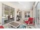 Inviting sunroom with tiled floor, comfortable seating, and expansive windows for natural light at 1748 Sw 157Th Place Rd, Ocala, FL 34473