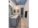 A full bathroom with tiled flooring, a sink, mirror, and towel rack at 21 Pecan Course Cir, Ocala, FL 34472
