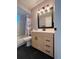 Well-lit bathroom featuring a modern vanity, stylish light fixture, and a shower-tub combination with a curtain at 21 Pecan Course Cir, Ocala, FL 34472