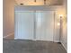 A bedroom with two closets and neutral paint and carpet at 21 Pecan Course Cir, Ocala, FL 34472