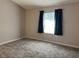A bedroom with a window and neutral color walls and flooring at 21 Pecan Course Cir, Ocala, FL 34472