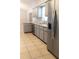 Modern kitchen featuring stainless steel appliances, gray cabinets, a double sink, and tiled flooring at 21 Pecan Course Cir, Ocala, FL 34472